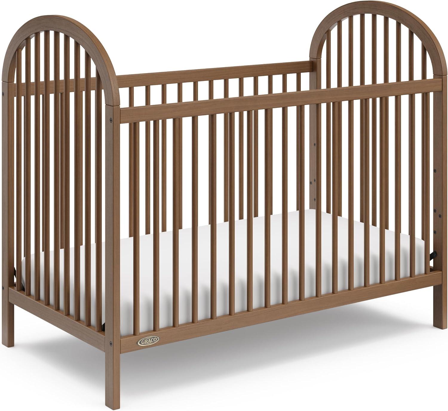 imageGraco Olivia Convertible Crib Black GREENGUARD Gold Certified 100 Solid Wood Fits Standard Crib Mattress Converts to Toddler Bed and Daybed 4 Adjustable Mattress HeightsHazelnut