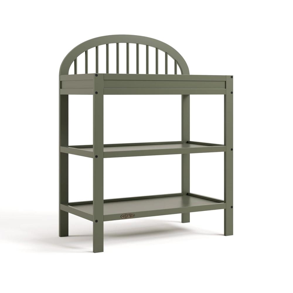 imageGraco Olivia Changing Table with WaterResistant Changing Pad Black GREENGUARD Gold Certified Includes Bonus WaterResistant Changing Pad with Safety Strap 2 Open Shelves Stylish DesignOlive