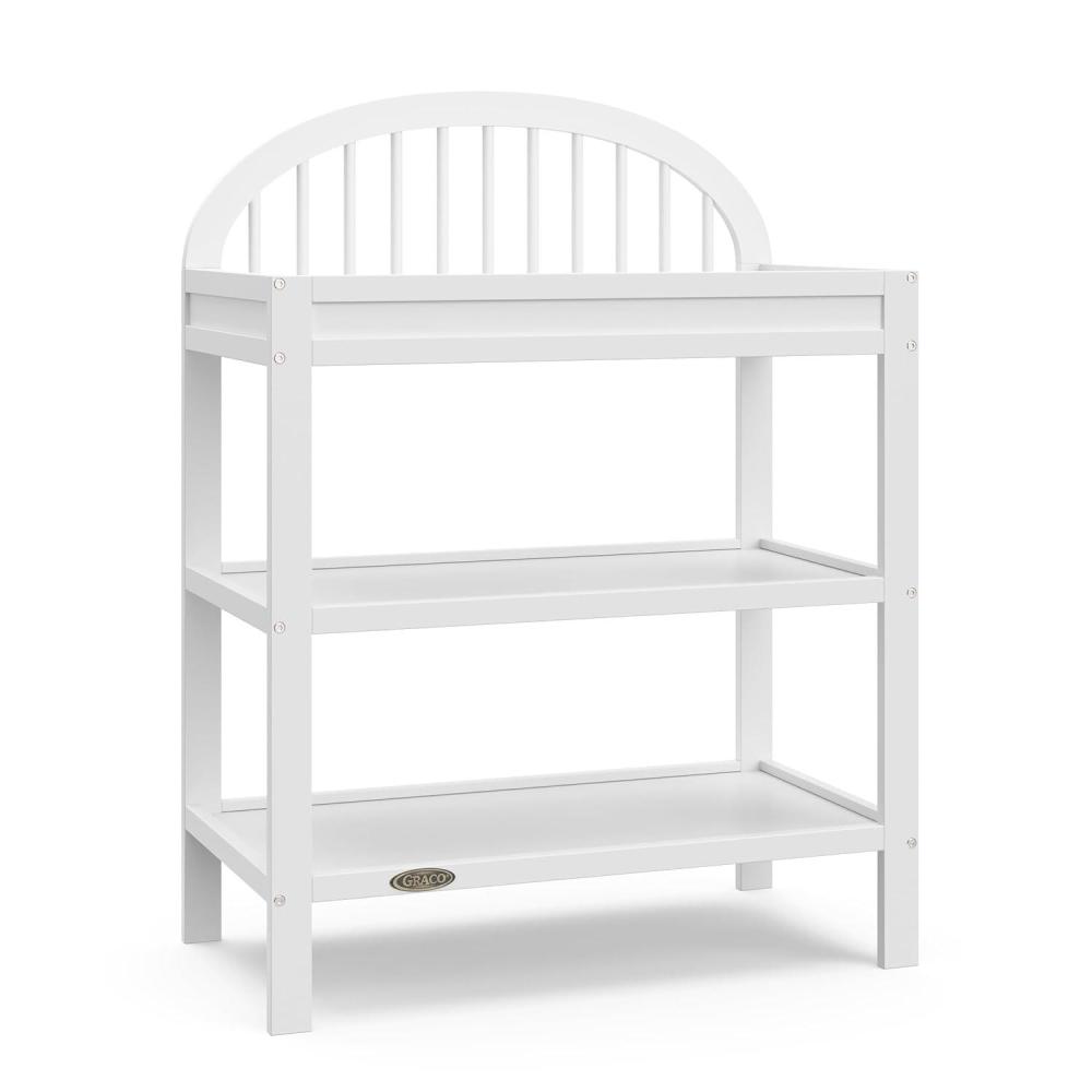 imageGraco Olivia Changing Table with WaterResistant Changing Pad Black GREENGUARD Gold Certified Includes Bonus WaterResistant Changing Pad with Safety Strap 2 Open Shelves Stylish DesignWhite