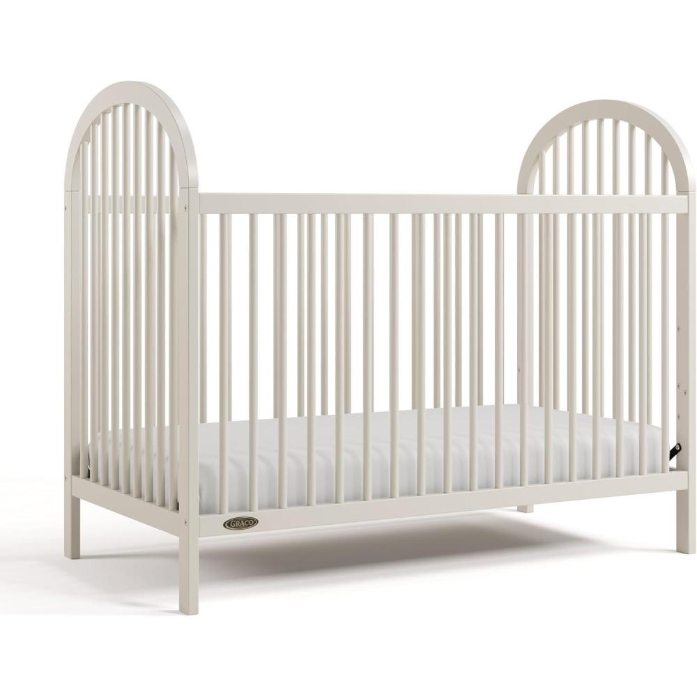 imageGraco Olivia Convertible Crib Black GREENGUARD Gold Certified 100 Solid Wood Fits Standard Crib Mattress Converts to Toddler Bed and Daybed 4 Adjustable Mattress HeightsFrosted Oat
