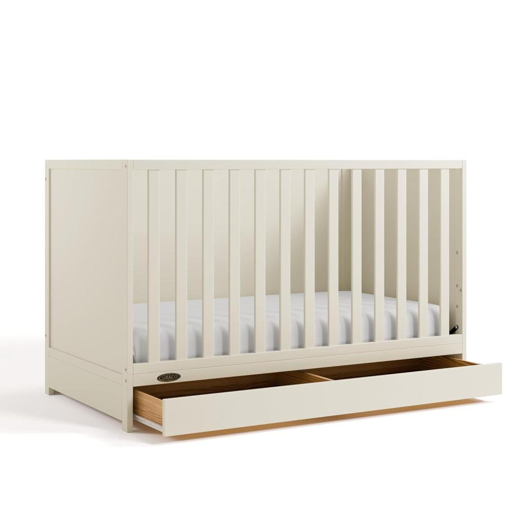 imageGraco Theo Convertible Crib with Storage Drawer Frosted Oat  GREENGUARD Gold Certified Wooden Baby Crib with Drawer Converts to Toddler Bed Fits Standard Crib MattressFrosted Oat